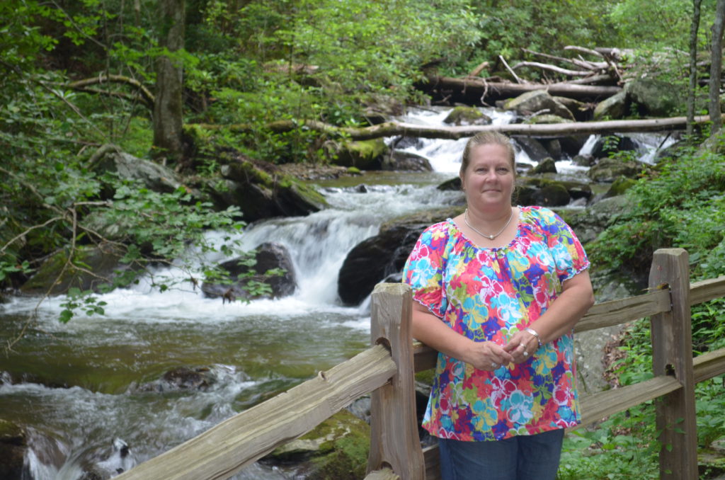 Lori beside the river along the trail to Anna Ruby Falls