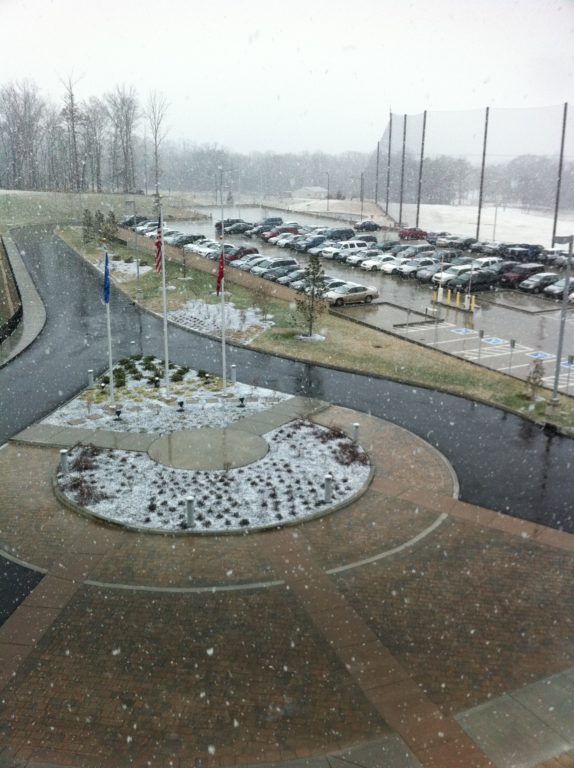 Snow beginning to lay on the ground at work